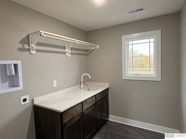 laundry room featuring cabinets, sink, and electric dryer hookup