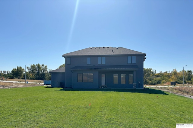 back of house featuring a lawn