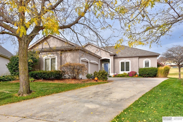 view of front of house with a front yard and a garage