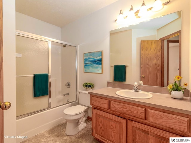 full bathroom featuring vanity, enclosed tub / shower combo, and toilet