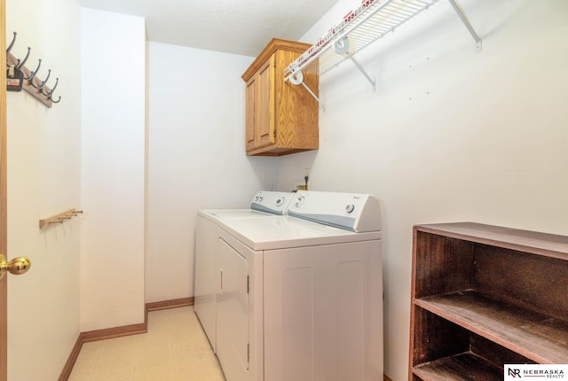 washroom featuring cabinets and washer and dryer