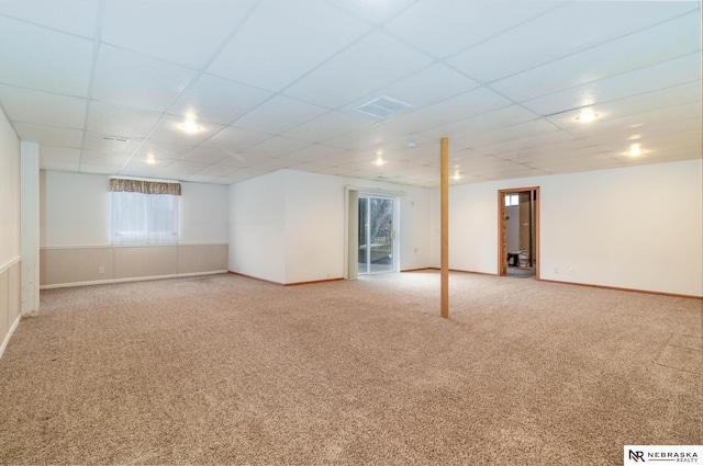 basement with carpet and a paneled ceiling