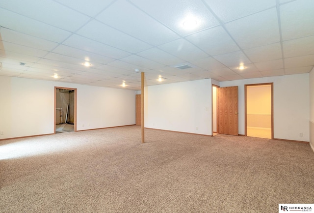 basement with carpet flooring and a paneled ceiling