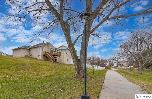 view of property exterior featuring a lawn and a deck