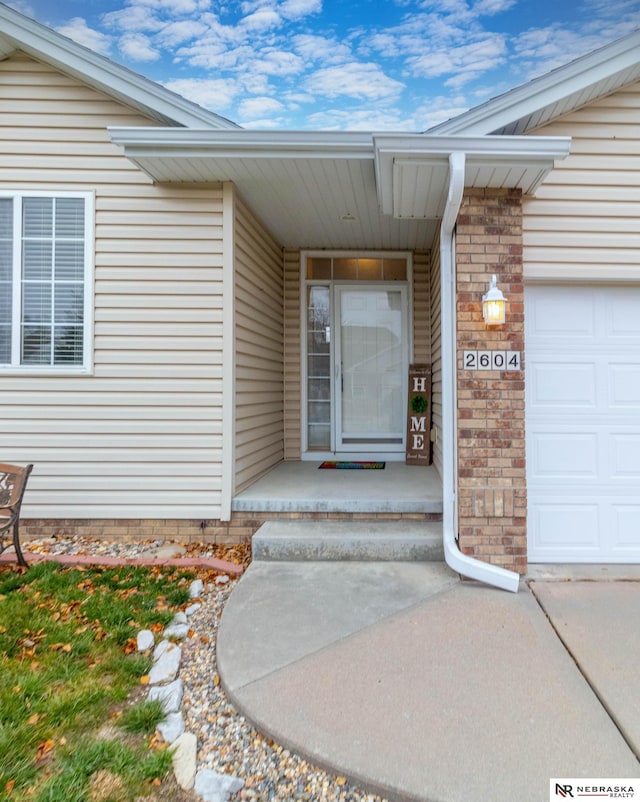 doorway to property with a garage