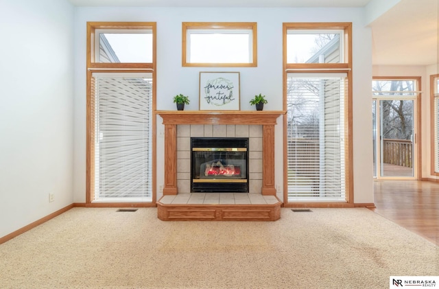 unfurnished living room featuring carpet and a fireplace