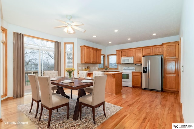 dining room featuring light hardwood / wood-style floors, plenty of natural light, and ceiling fan