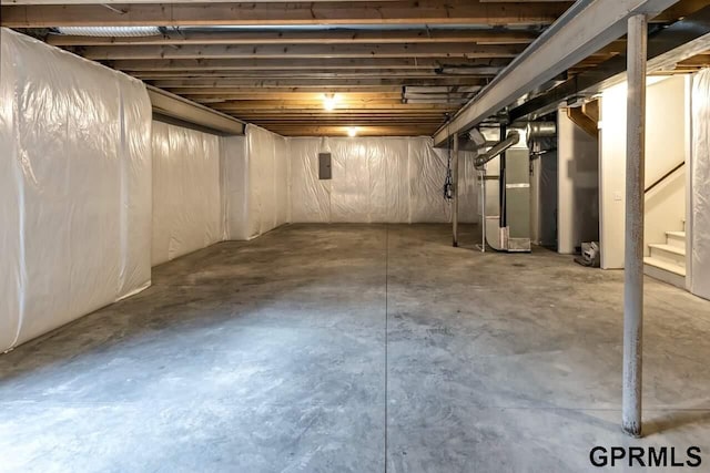 basement with electric panel and heating unit