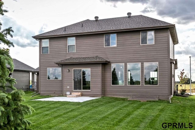 back of property with a lawn and a patio area