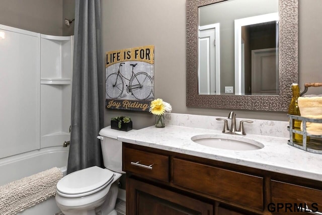 full bathroom featuring toilet, shower / bath combo, and vanity