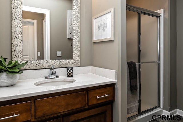 bathroom featuring an enclosed shower and vanity