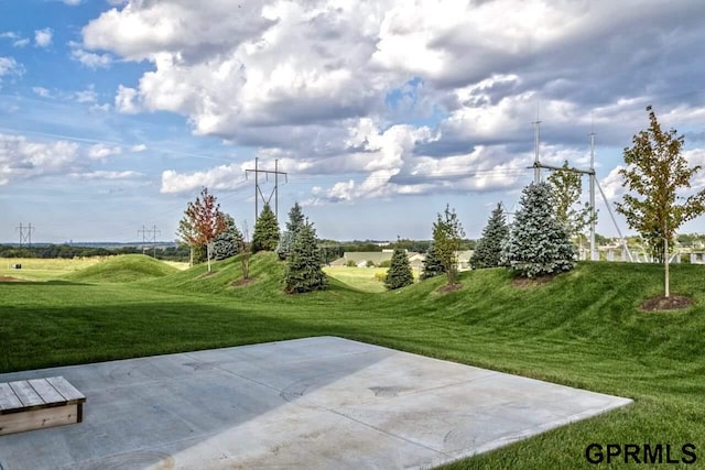 view of home's community featuring a lawn and a patio