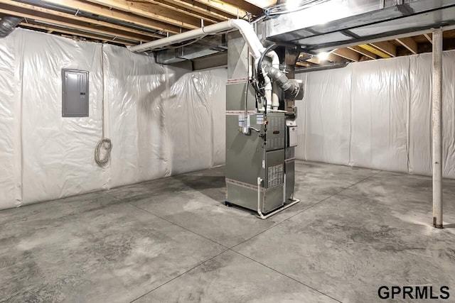 basement featuring electric panel and heating unit