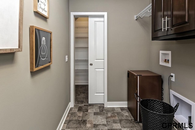 clothes washing area with hookup for a washing machine and cabinets