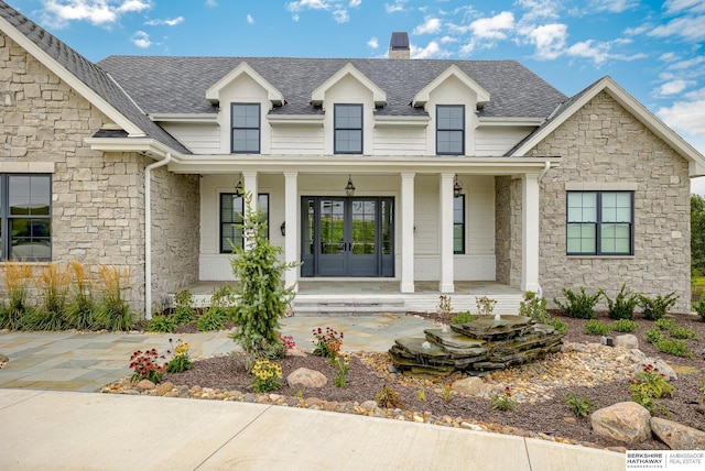 view of front of property with french doors and a porch