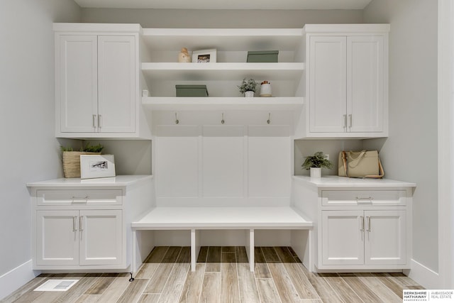 mudroom with light hardwood / wood-style floors