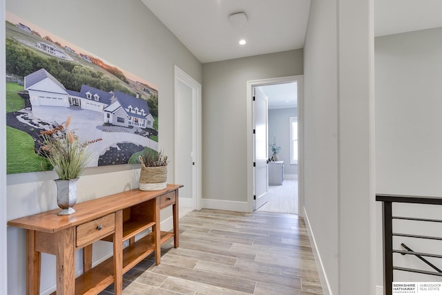 hall with light hardwood / wood-style floors