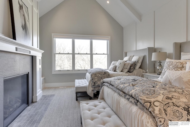 bedroom with high vaulted ceiling and a tiled fireplace