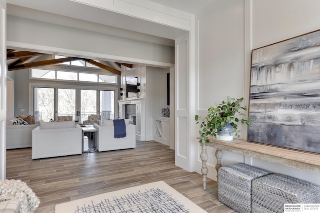 living room featuring french doors and lofted ceiling with beams