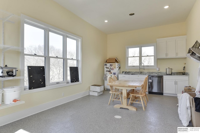 kitchen with white cabinetry, dishwasher, white fridge, and plenty of natural light