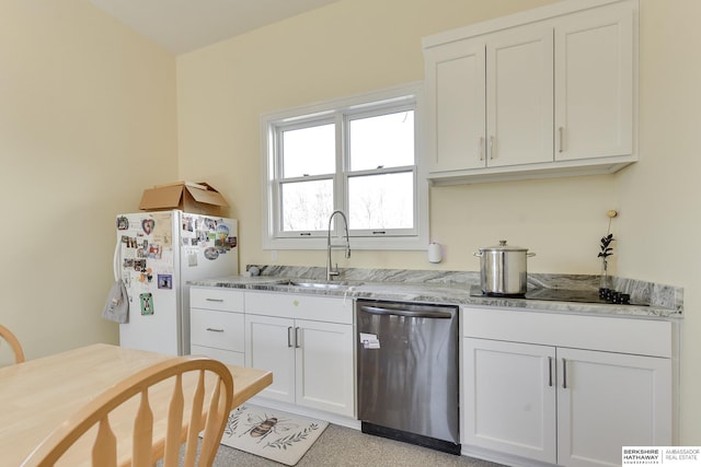 kitchen featuring light stone countertops, white cabinetry, sink, stainless steel dishwasher, and white fridge