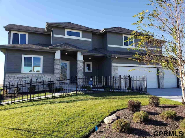 prairie-style house with a front yard and a garage