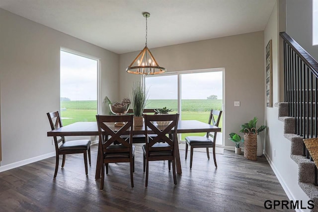 dining room with a notable chandelier and dark hardwood / wood-style floors