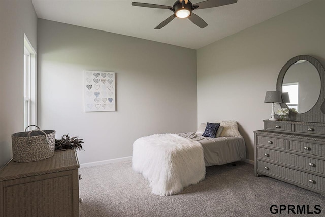 bedroom with ceiling fan, carpet flooring, and multiple windows