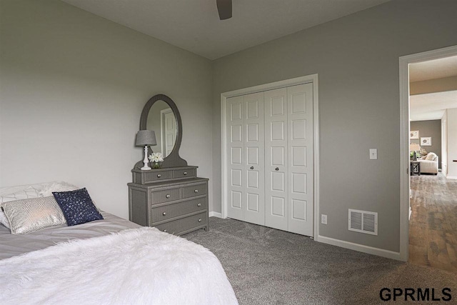 carpeted bedroom with ceiling fan and a closet