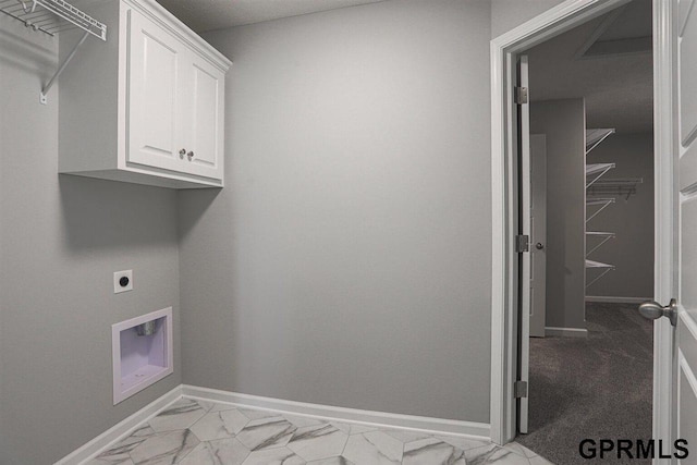 laundry room with electric dryer hookup and cabinets