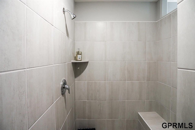 bathroom with a tile shower