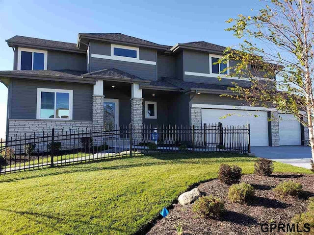 view of front facade featuring a front yard and a garage