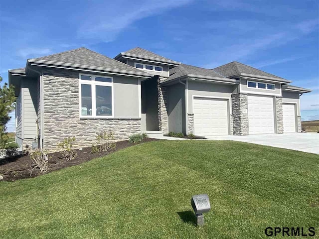 prairie-style home with a garage and a front yard