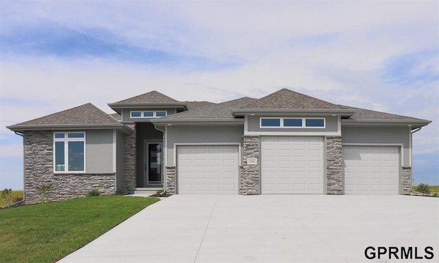 prairie-style house with a front yard and a garage