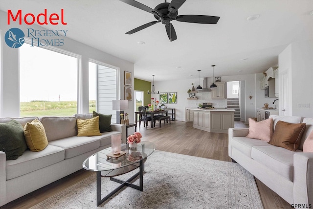 living room featuring ceiling fan and hardwood / wood-style flooring