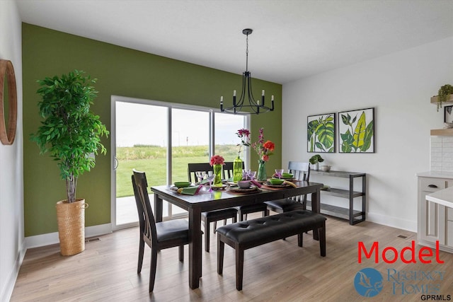 dining area with a notable chandelier and light hardwood / wood-style flooring