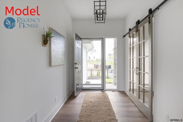 doorway to outside featuring french doors, plenty of natural light, and hardwood / wood-style flooring