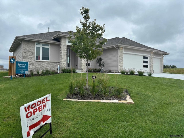 prairie-style home with a front lawn and a garage