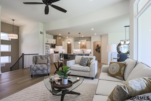 living room with hardwood / wood-style floors and ceiling fan