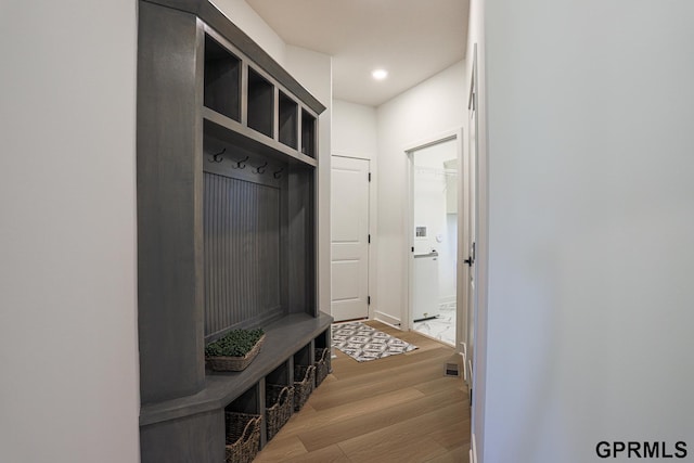 mudroom with baseboards, wood finished floors, visible vents, and recessed lighting