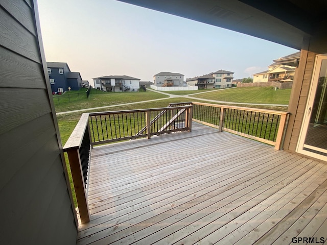 deck with a lawn and a residential view