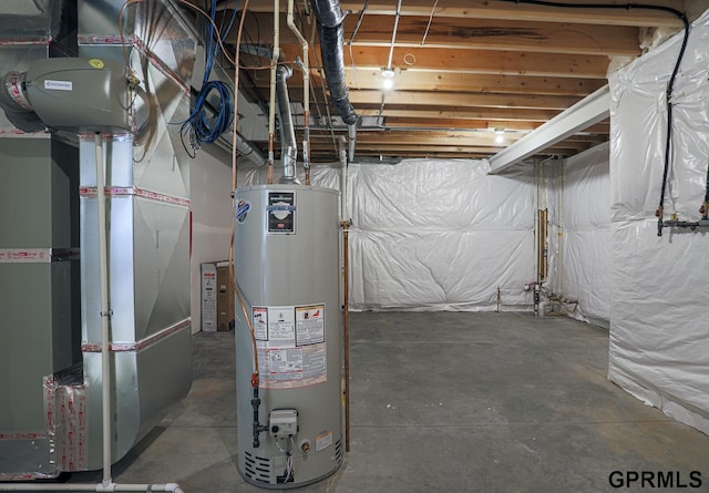 unfinished basement featuring gas water heater and heating unit