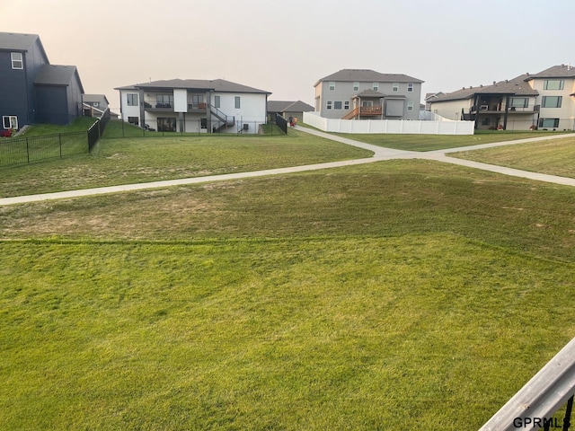 view of yard featuring a residential view and fence