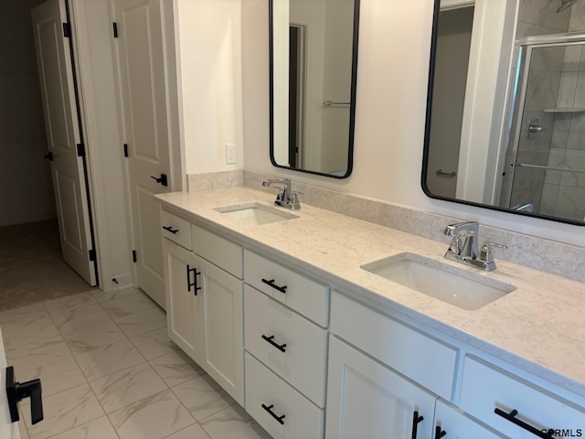 bathroom featuring vanity and a shower with door