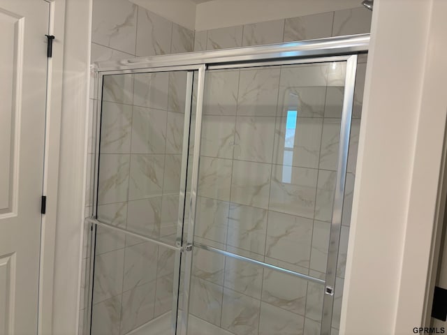 bathroom with a shower with shower door