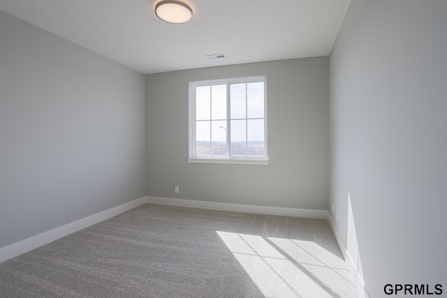 unfurnished room with light carpet