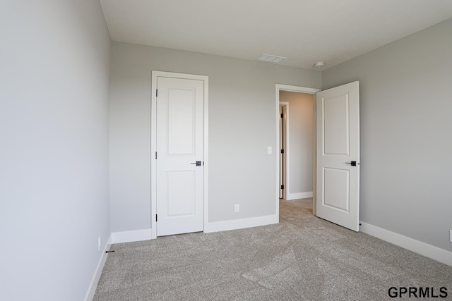 unfurnished bedroom with light colored carpet