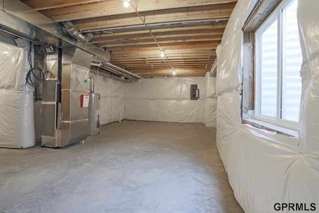 basement with electric panel, water heater, and heating unit