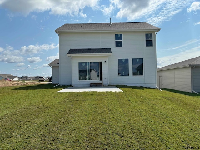 back of property featuring a lawn and a patio