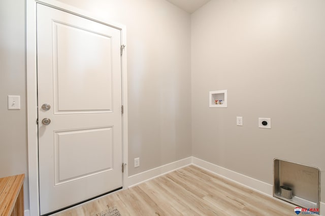 clothes washing area with electric dryer hookup, washer hookup, and light wood-type flooring